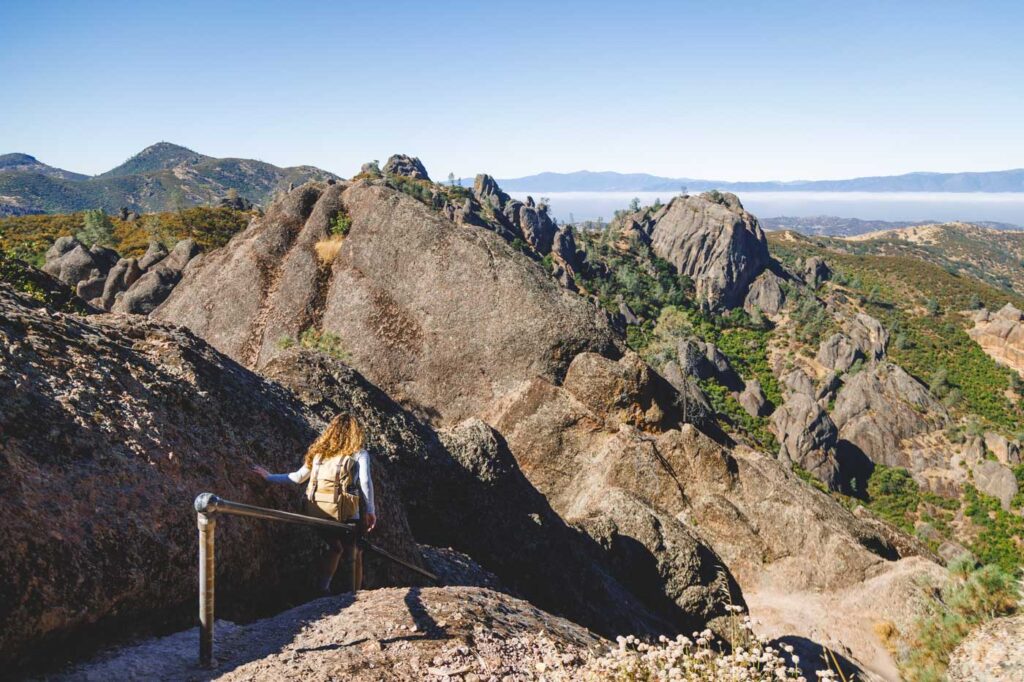 Nina hiking in Pinnacles National Park with cool rocks everywhere.