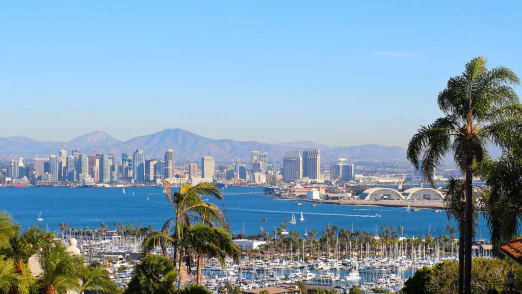 San Diego skyline with the ocean and mountain in the back.