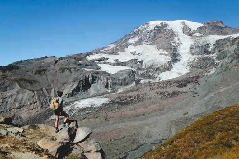 Nina on the Skyline Trail with Mount Rainier in the distance with a bit of snow on it.