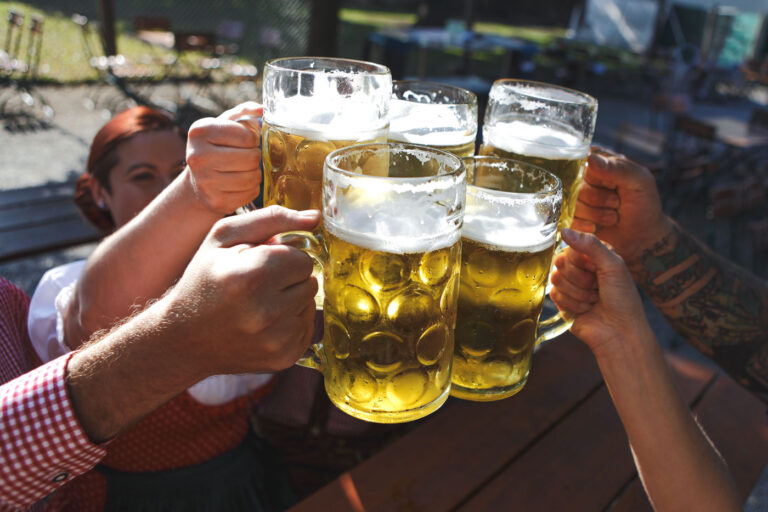 Five mugs of beer cheersing at Leavenworth's Oktoberfest.