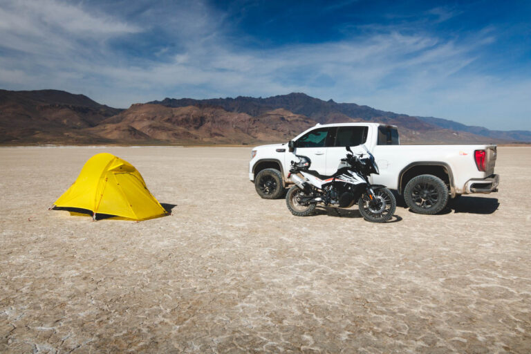Tent, motorcycle, and truck on the Alvord Desert.
