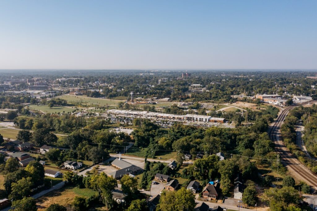 Aerial view of a suburban town with trees and buildings.