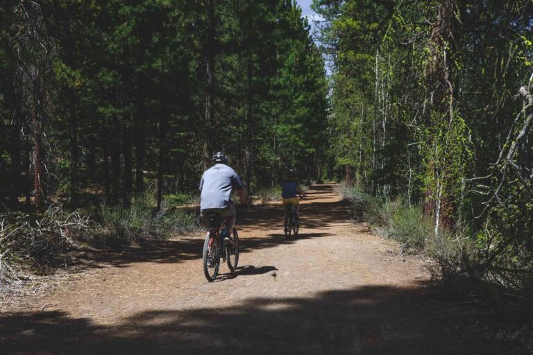 Mountain biker riding a dirt singletrack trail through an Oregon forest