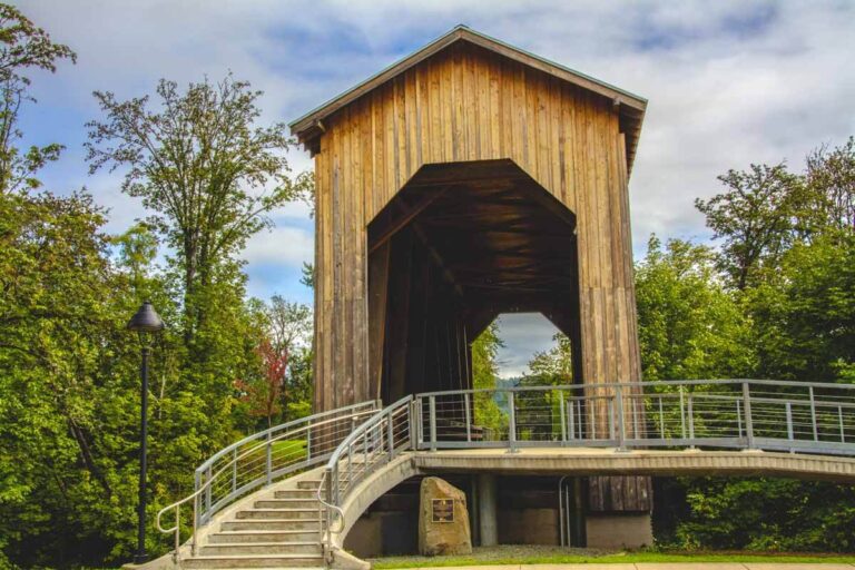 Cyclist riding through the Chambers Railroad covered bridge near Cottage Grove, Oregon