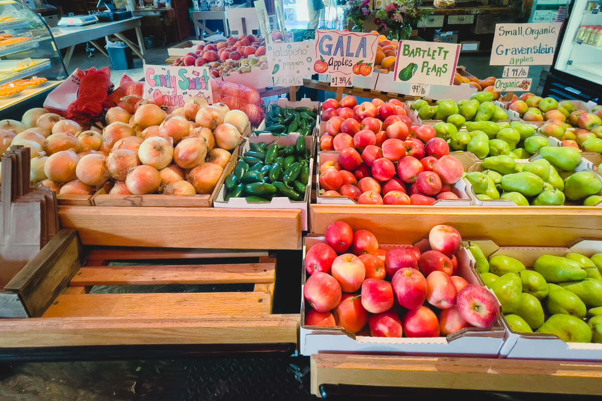 A fruit stall stacked with fresh peaches and other stone fruit at Johnson Orchards Market in the Yakima Valley, Washington